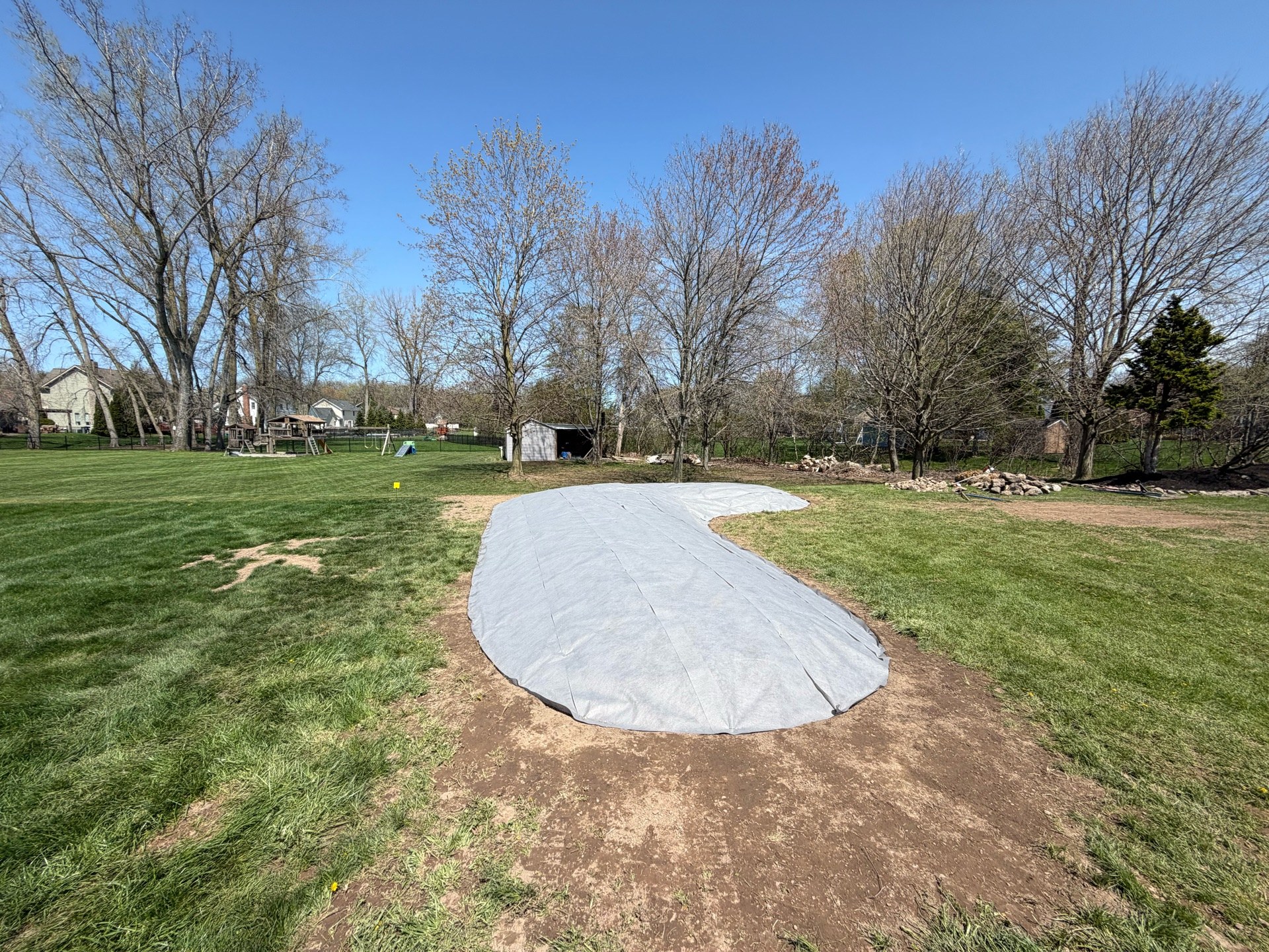 Landscape fabric laid over the releveled bed