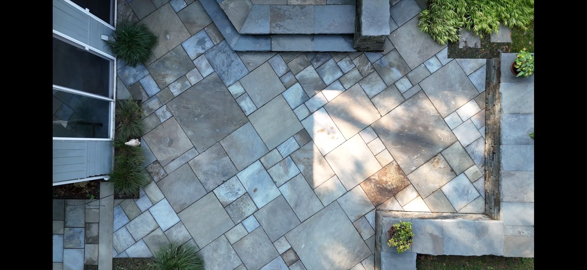 Drone view of a restored bluestone patio by LandX Landscape (Photo 1)