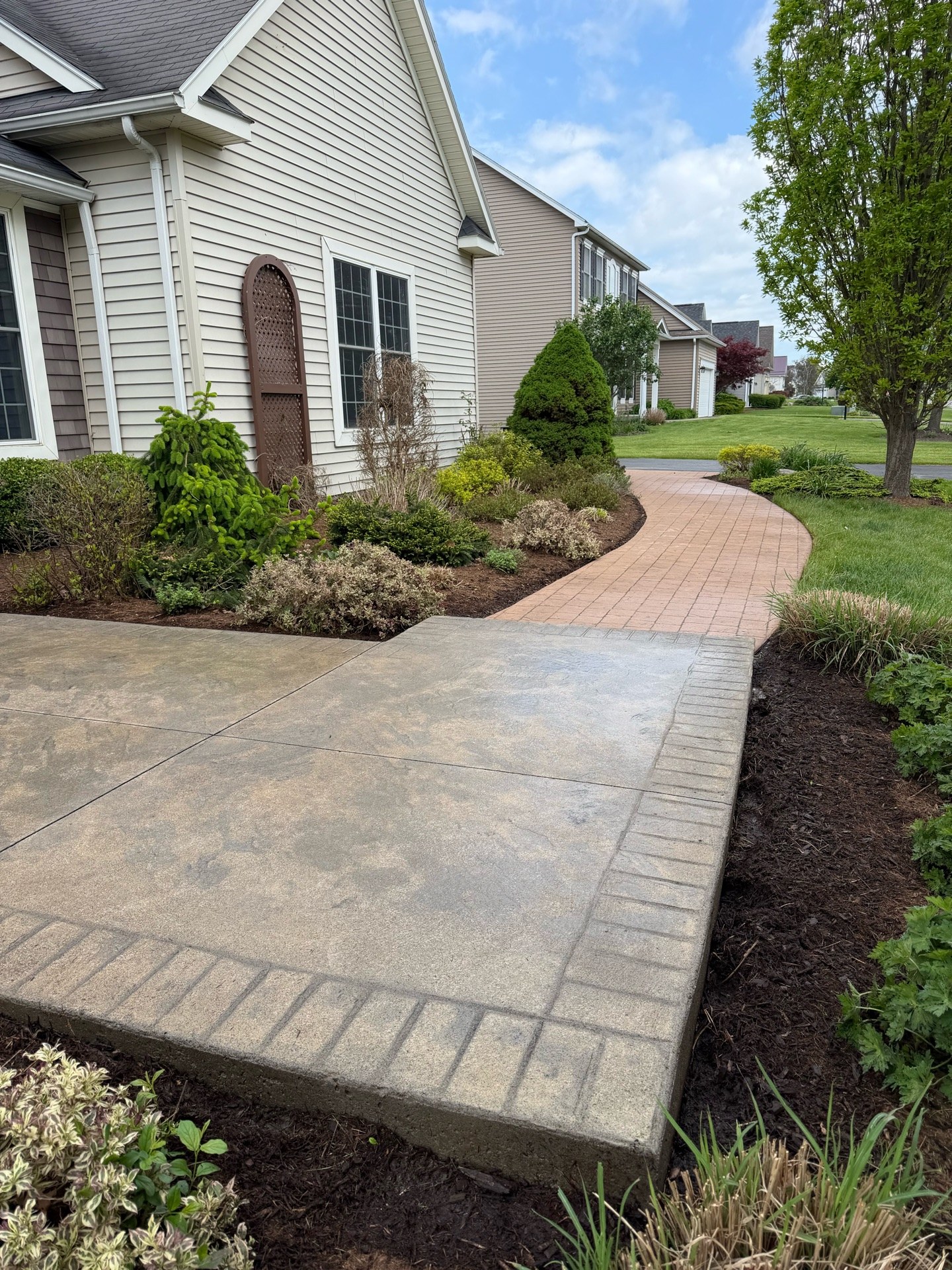 Stamped concrete walkway restoration — pressure washed and seal coated (After 1)