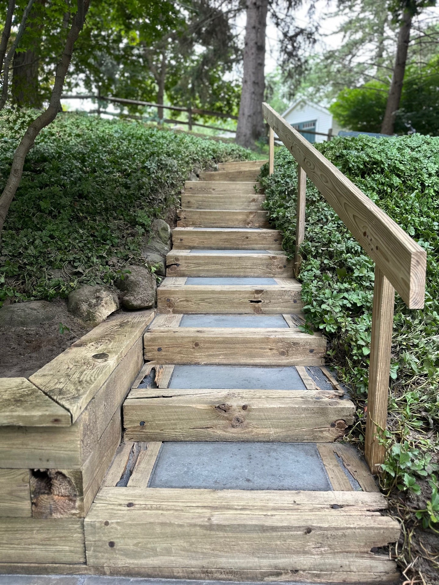 Blue slate patio and stair restoration — moss and mold cleaned, wooden retaining wall washed, joints refilled with polymer sand (After 1)